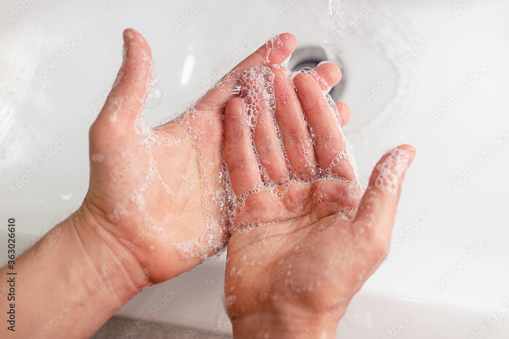 Closeup of person washing hands with soap. Closeup of person washing hands with soap.
