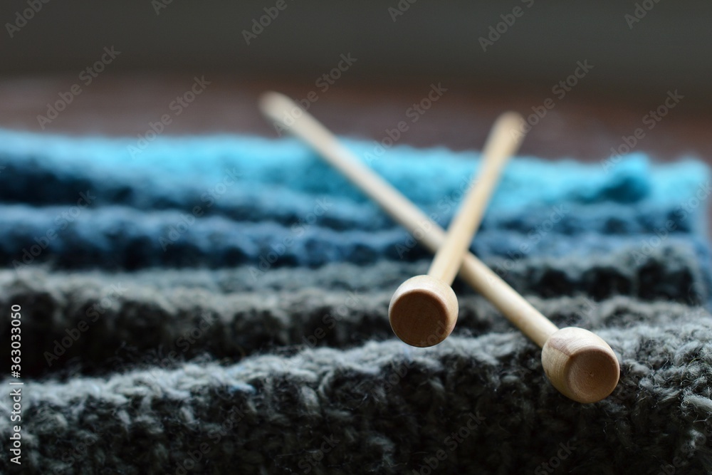 Wool yarn knitted into a blue scarf Wool yarn knitted into a blue scarf