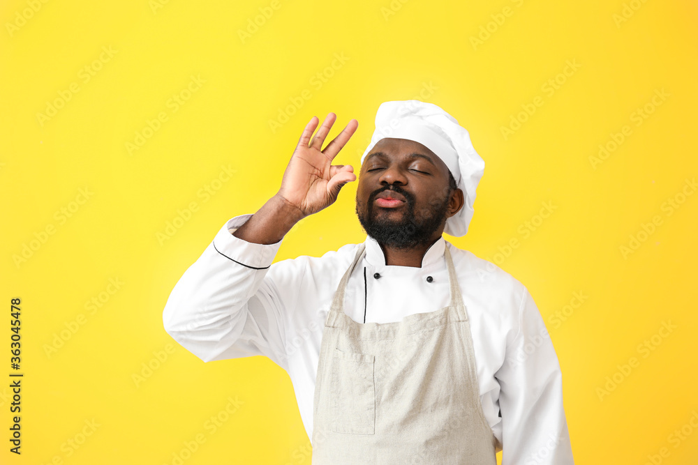 Male African-American chef on color background Male African-American chef on color background