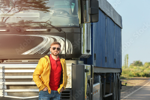 Male driver near big truck ...