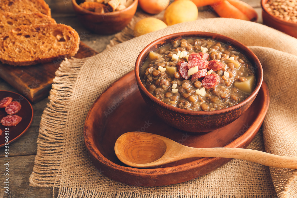 Fototapeta premium Bowl of tasty lentils soup on table