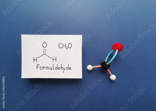 Molecular structure model and structural chemical formula of formaldehyde molecule. Formaldehyde (methanal) is an organic compound; it is the simplest of the aldehydes. Black=C, white=H, red=O. photo