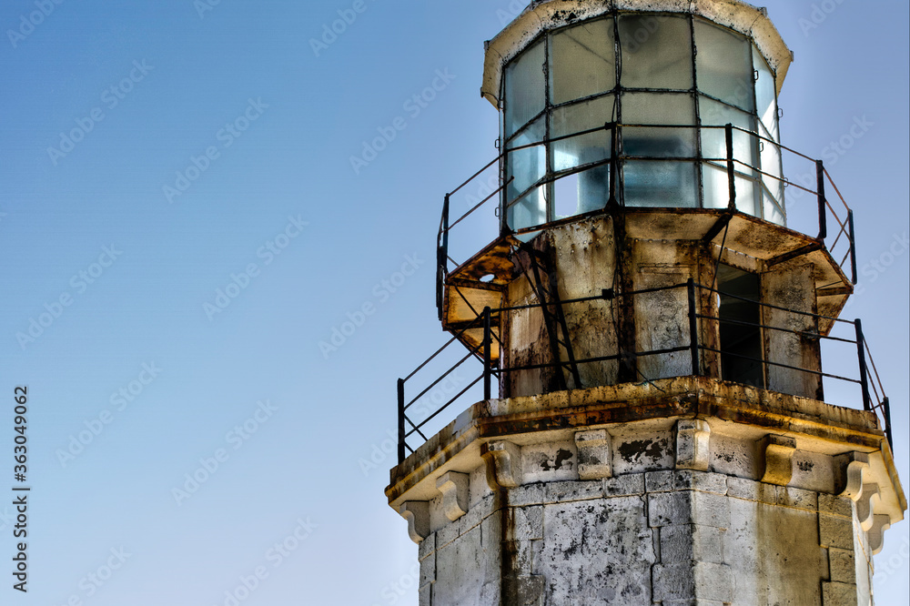 abandoned lighthouse with clear deterioration over time