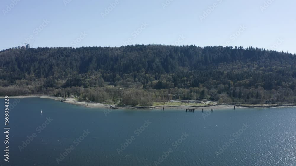Drone over water in British Columbia (BC). West coast sunny day along the Indian Arm with mountains in the background Drone over water in British Columbia (BC). West coast sunny day along the Indian Arm with mountains in the background
