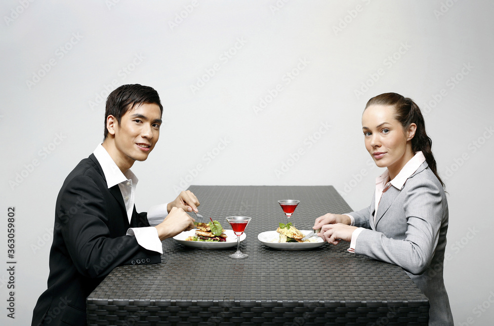 Businessman and businesswoman having dinner together Businessman and businesswoman having dinner together