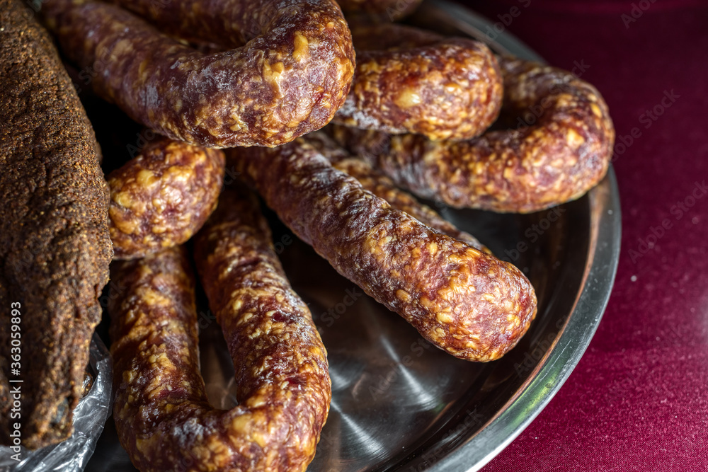 Smoked sausages lie on a large dish. Smoked sausages lie on a large dish.