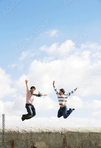 Two men jumping