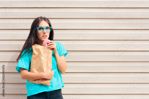 Funny Girl Eating Donuts Strait Out of a Paper Bag