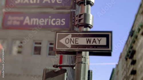 A one way sign in the corner of Sixth avenue also knows as Av of The Americas, in New York City