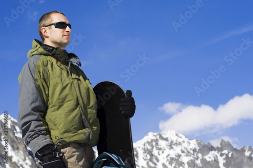 A man holding snowboard
