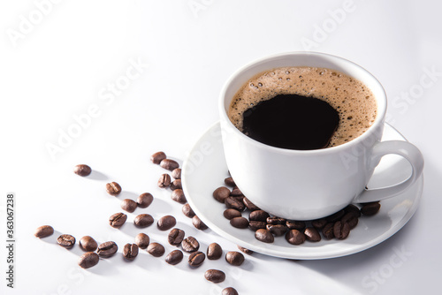 Coffee cup and coffee beans on white background