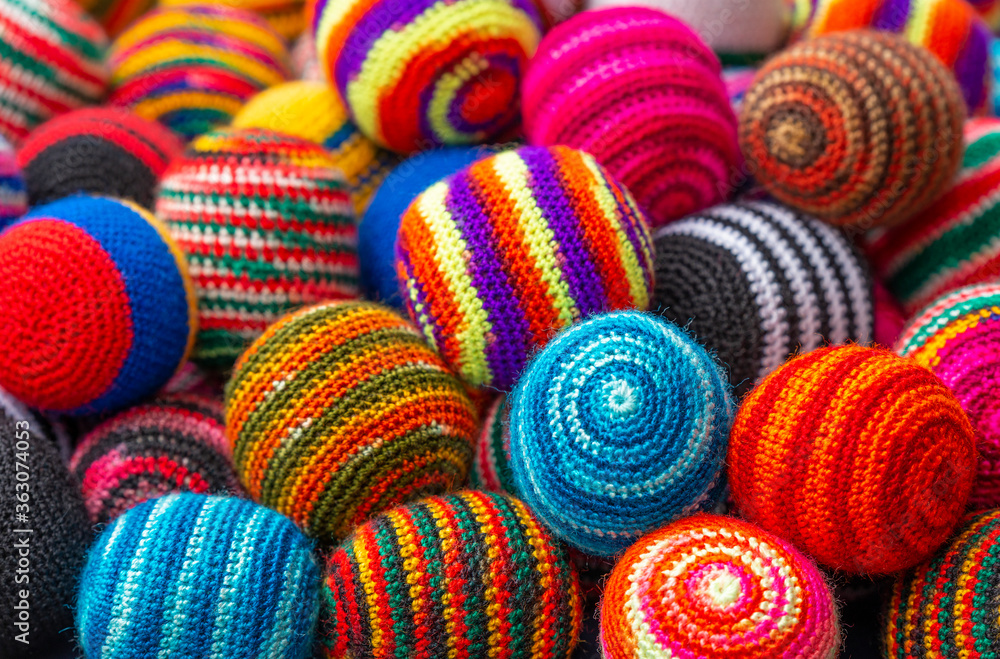 Colorful fabric textile wool balls on the Andes craft market of Otavalo, north of Quito, Ecuador.