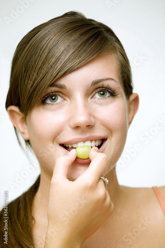 Girl eating green grape