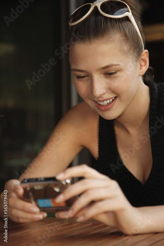 Woman looking at pictures taken in digital camera