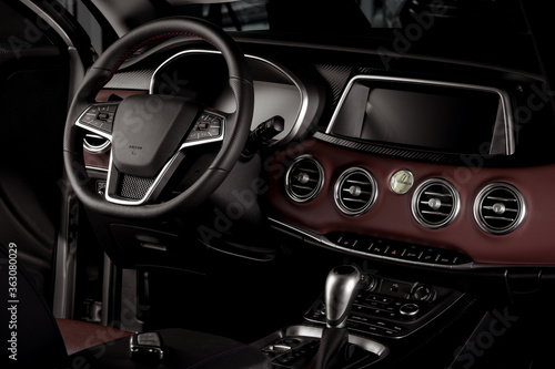 New car interior details with leather steering wheel, automatic transmission and touchscreen center console © JesusCarreon