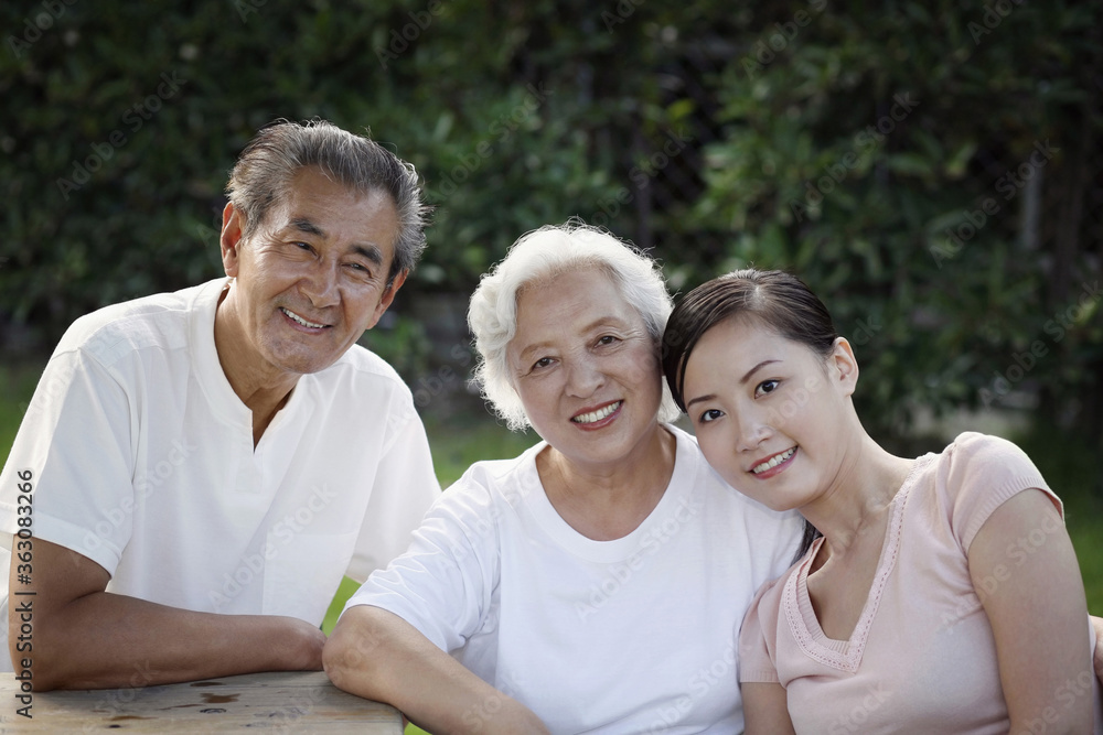 Woman posing with senior couple