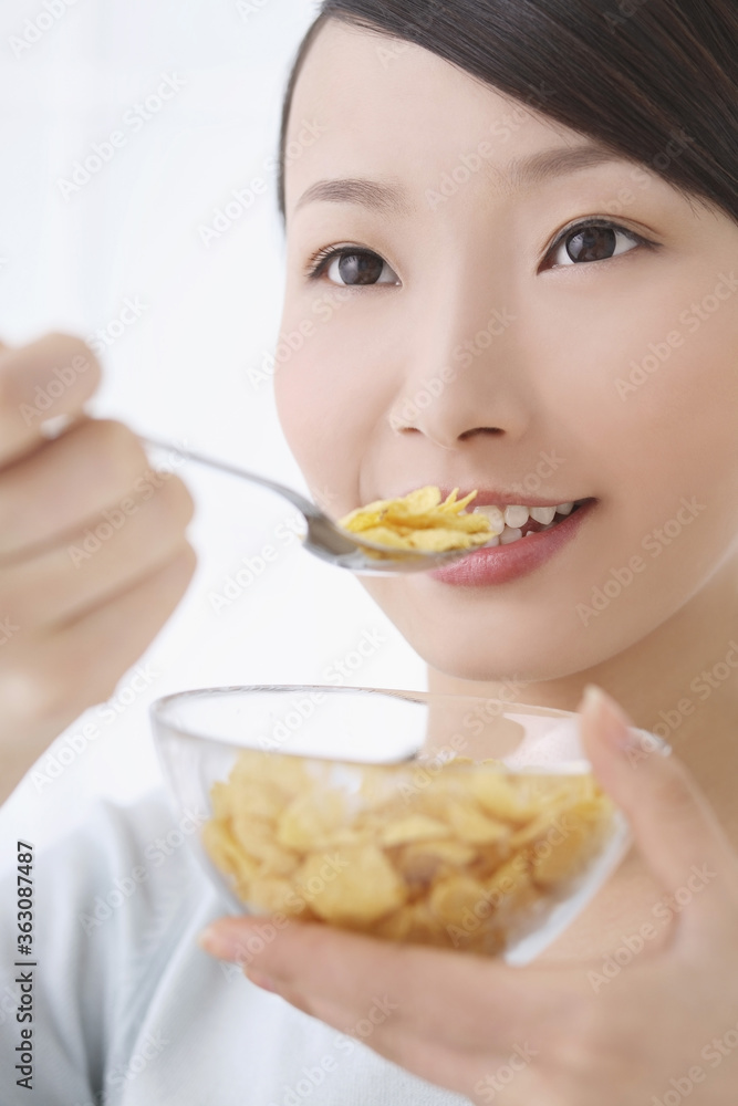 Woman enjoying a bowl of breakfast cereal Woman enjoying a bowl of breakfast cereal