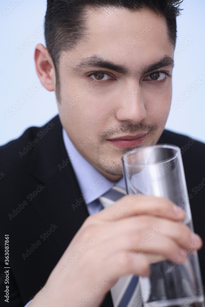 Businessman drinking a glass of water Businessman drinking a glass of water