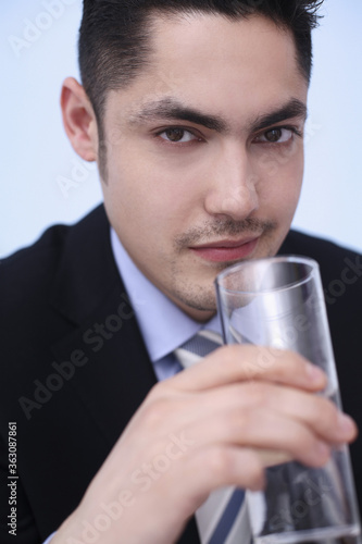 Businessman drinking a glass of water © ImageHit