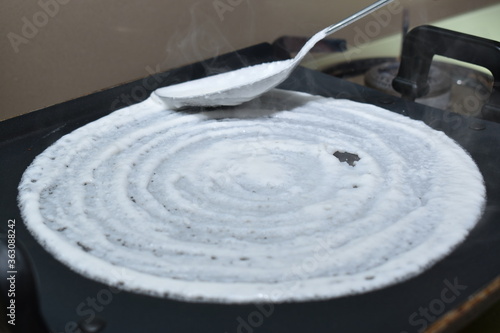 making, spreading, cooking, pouring, batter, white, tawa, spoon, dosa, idli, non stick, round, back, tasty, make, preparing, home made, pan, gas pipe, circular, south, india, indian, mumbai