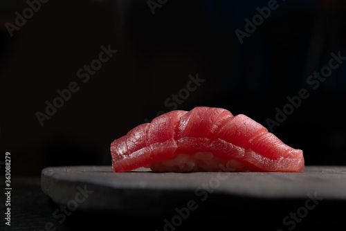 fine maguro shutoro nigiri sushi on stone with black background