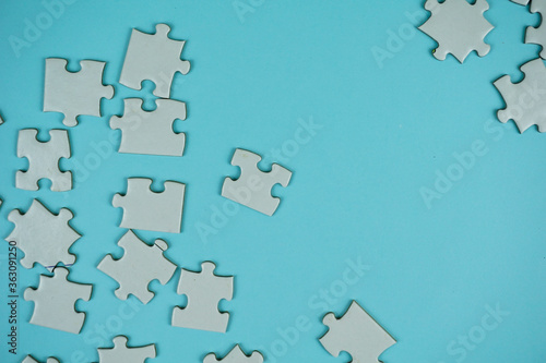 random jigsaw puzzle incomplete concept on blue background