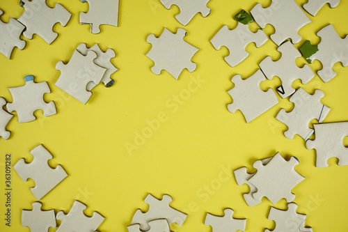 random jigsaw puzzle incomplete concept on yellow background