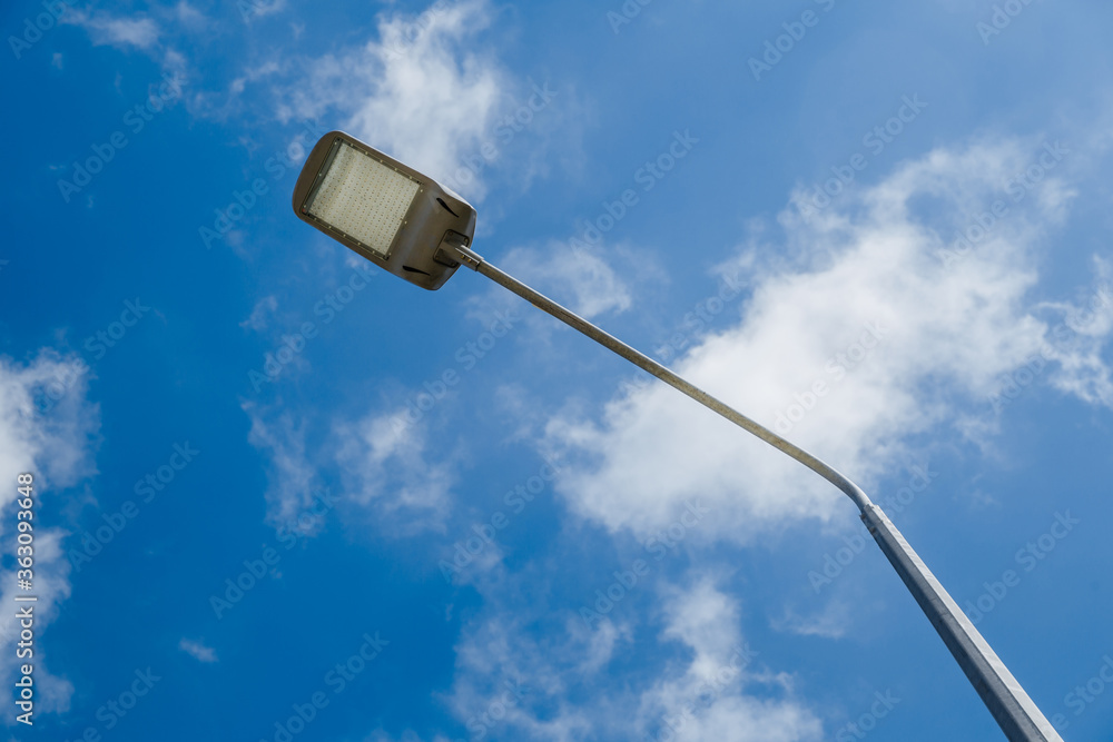 Street lantern on sky with white clouds background.A modern street LED lighting pole. Street lantern on sky with white clouds background.A modern street LED lighting pole.