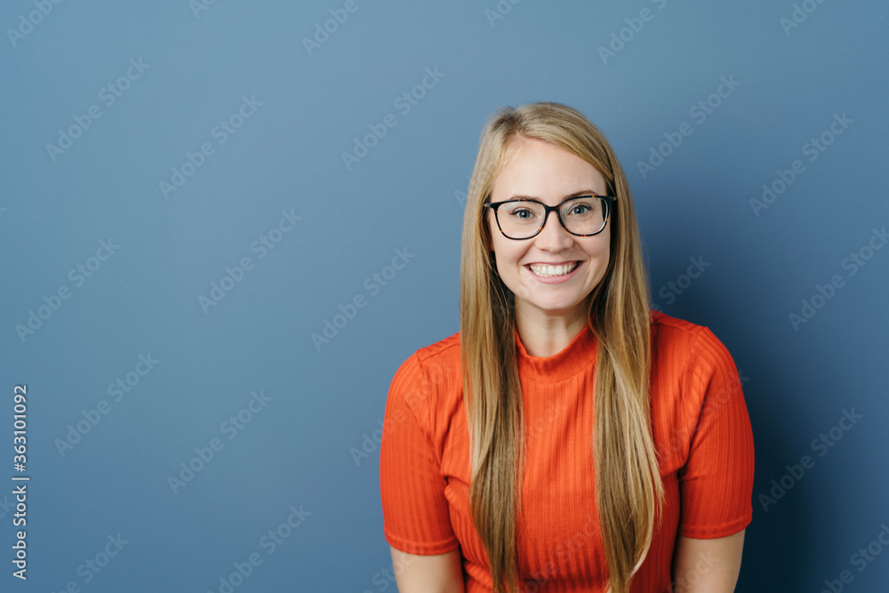 Excited young woman grinning happily at the camera Excited young woman grinning happily at the camera