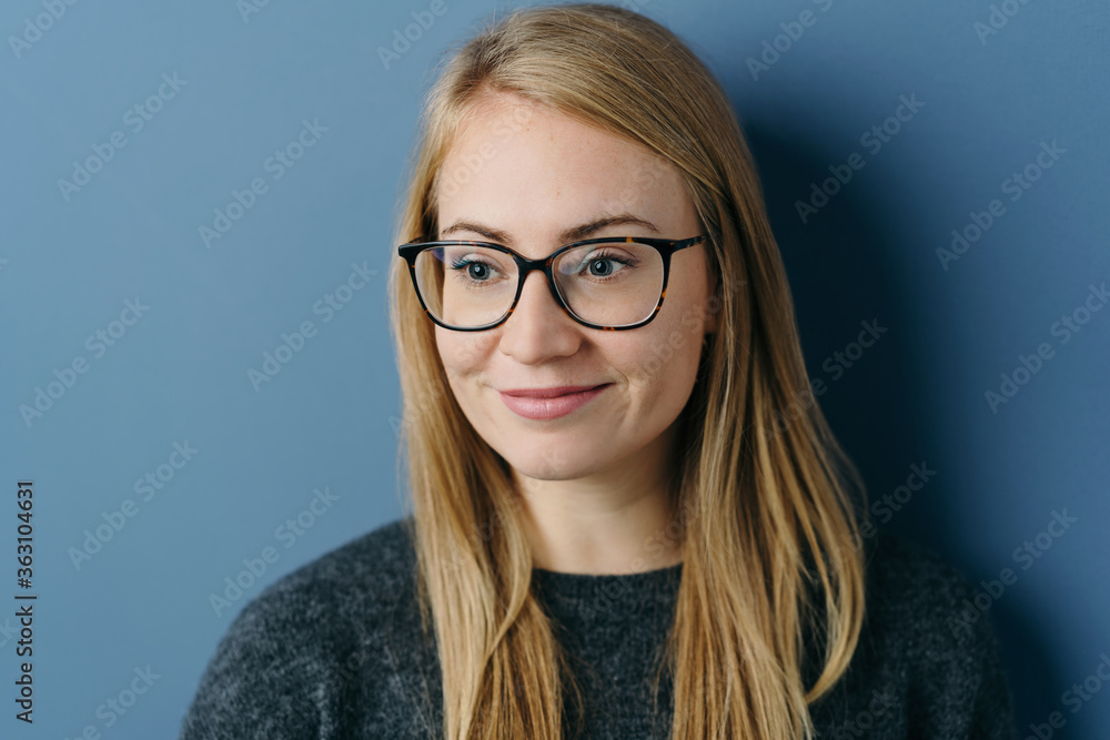 Young woman looking aside with a pleased smile Young woman looking aside with a pleased smile