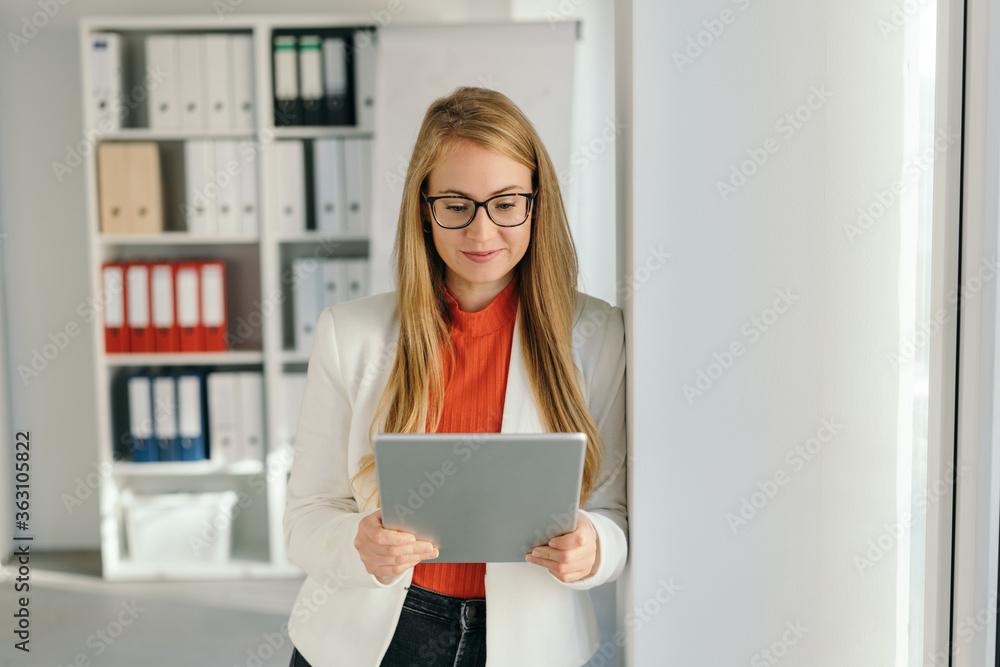 Smart young company employee standing reading Smart young company employee standing reading