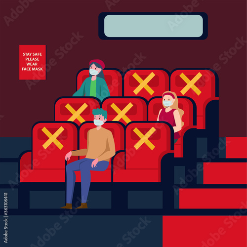 Peoples are watching movie at theatre while keeping their distance and using medical mask