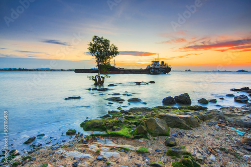 Tangker and barge in sunset on beach Batam island photo