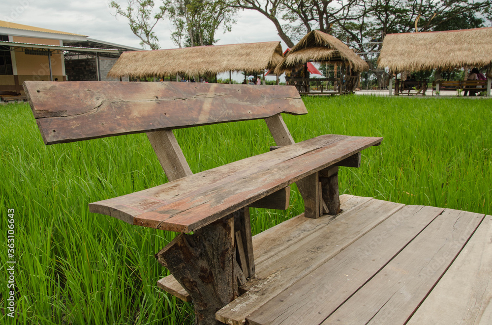 Wooden seat and floor in green field