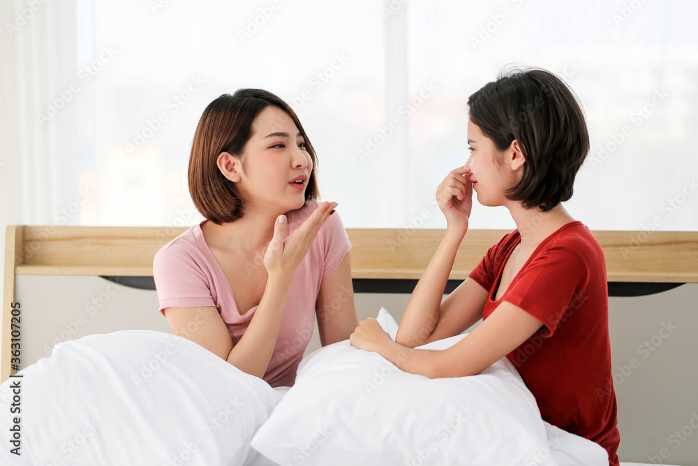 Happy Couple  asia woman  bored with bad breath in bedroom morning.