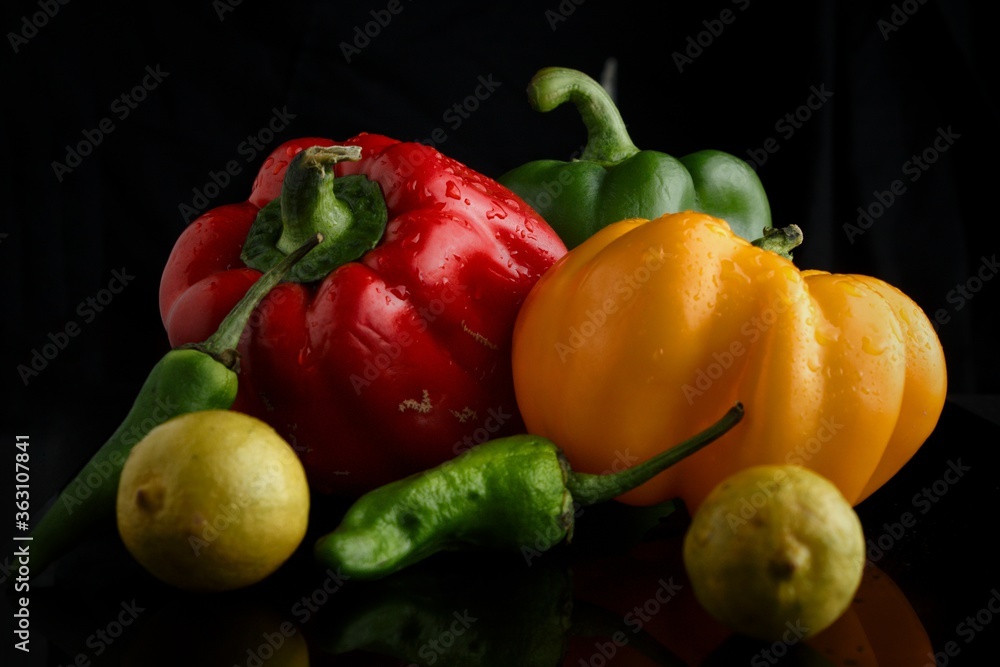 Fresh vegetables and fruits on black background