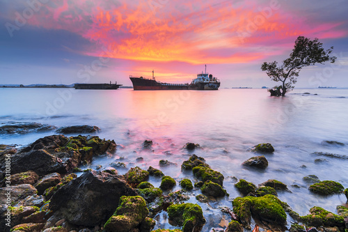 Tangker and barge in sunset on beach Batam island photo