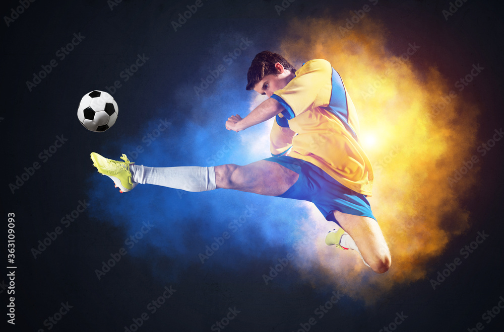 Soccer player kicking ball in colorful smoke