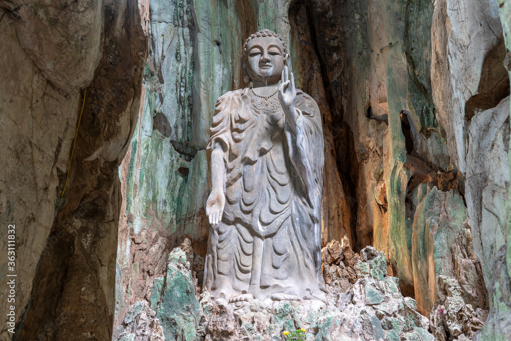 The great Buddha stone statue in the cave of Marble mountains, south of Da Nang city, Vietnam