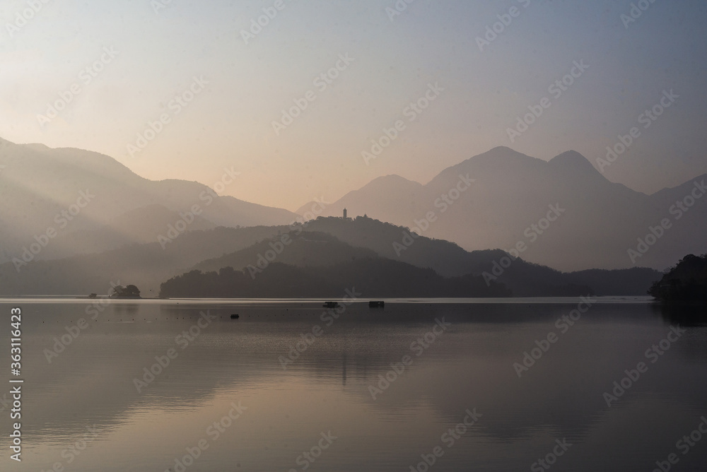 Fototapeta premium morning light shining in peaceful mountain in the lake