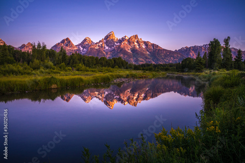 The sunrise view of Mount Grand Teton, with reflection in front.