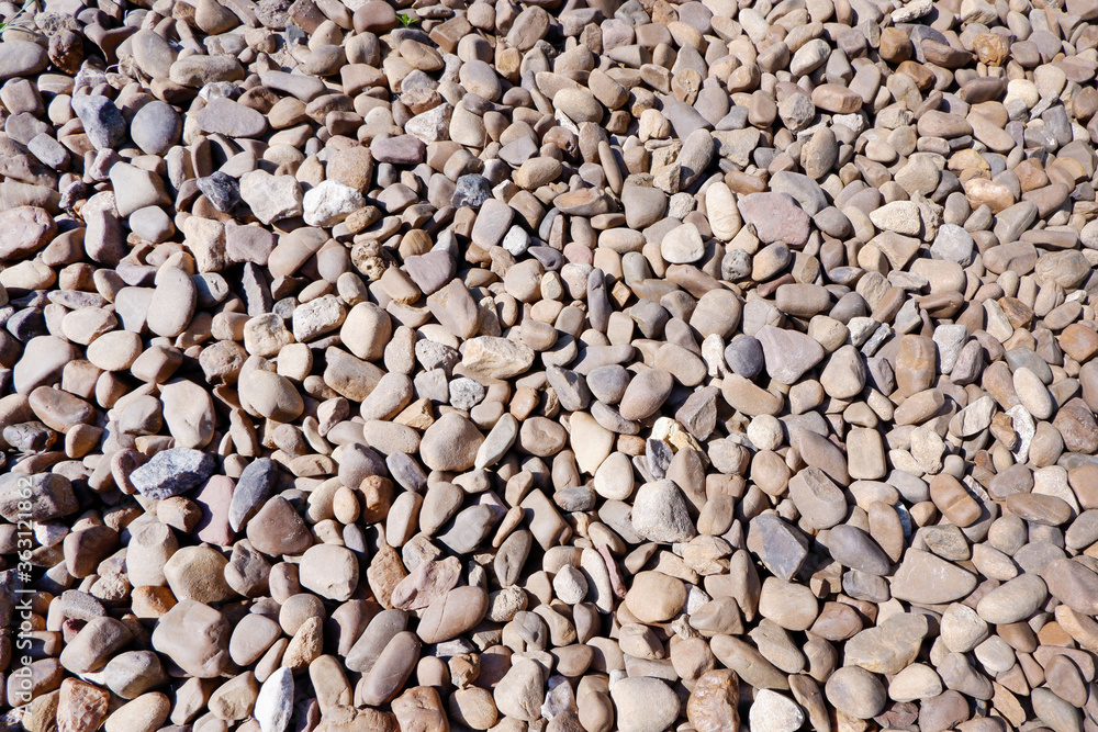 Texture of small stone or pebbles background. Sea stones in the garden Texture of small stone or pebbles background. Sea stones in the garden