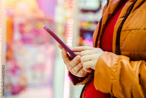 A woman writes in her smartphone at the mall 