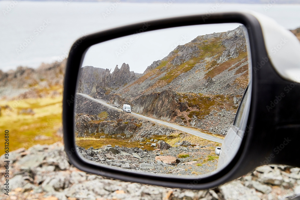 Car Mirror and reflection of tundra and sky in it. Car Mirror and reflection of tundra and sky in it.