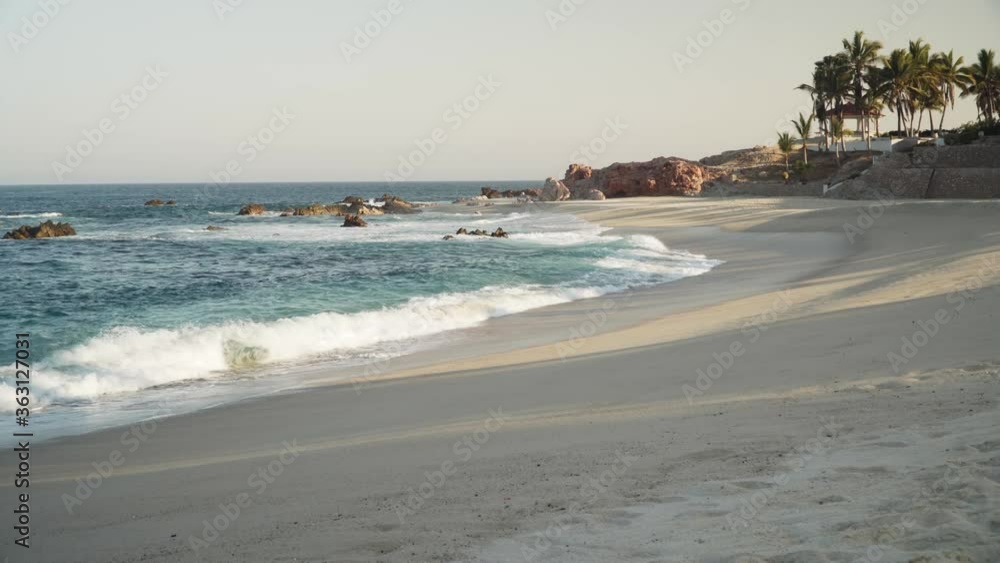 Handheld view of Cabo San Lucas beach coastline. Sunny day, blue water. Handheld view of Cabo San Lucas beach coastline. Sunny day, blue water.