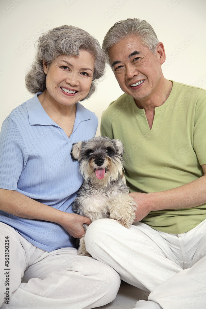 Senior man and senior woman posing with dog Senior man and senior woman posing with dog
