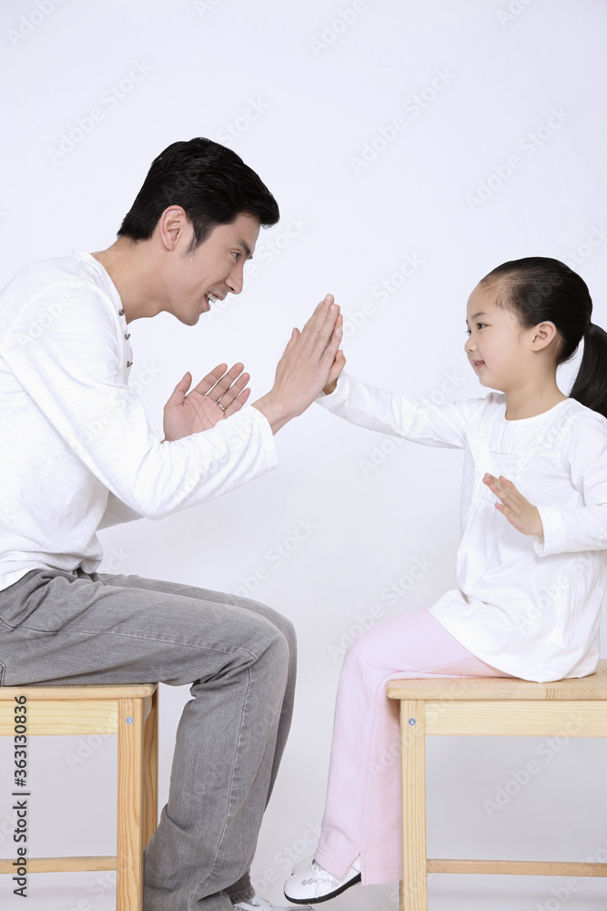 Man and girl having fun playing game Man and girl having fun playing game