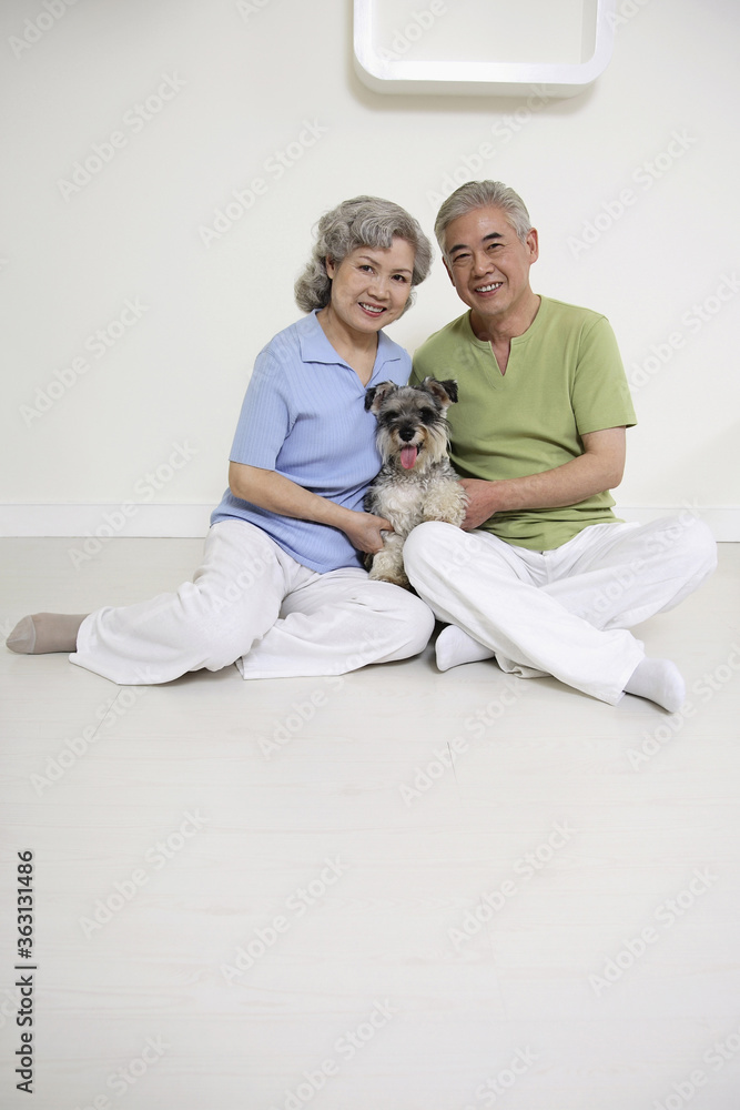 Senior man and senior woman posing with dog Senior man and senior woman posing with dog