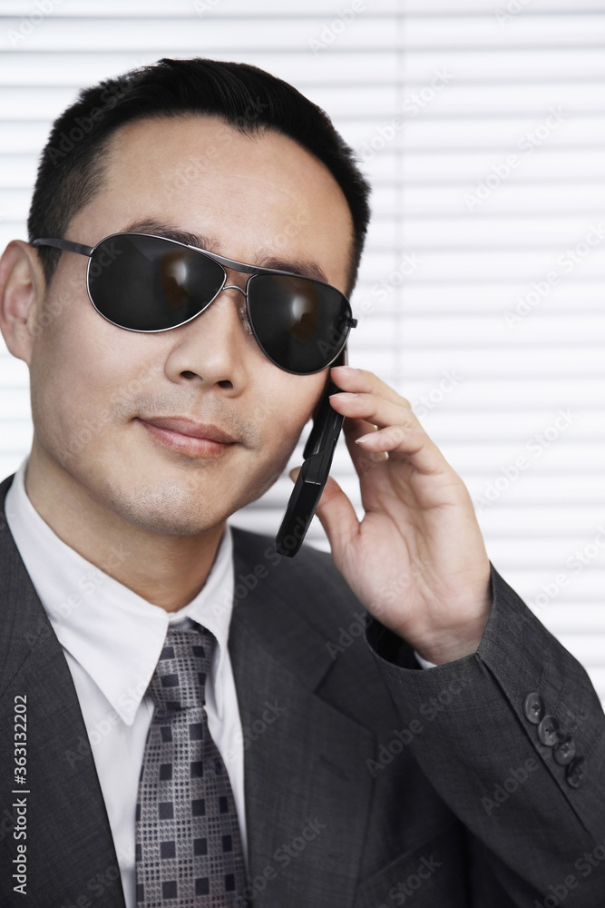 Businessman in sunglasses talking on the phone Businessman in sunglasses talking on the phone