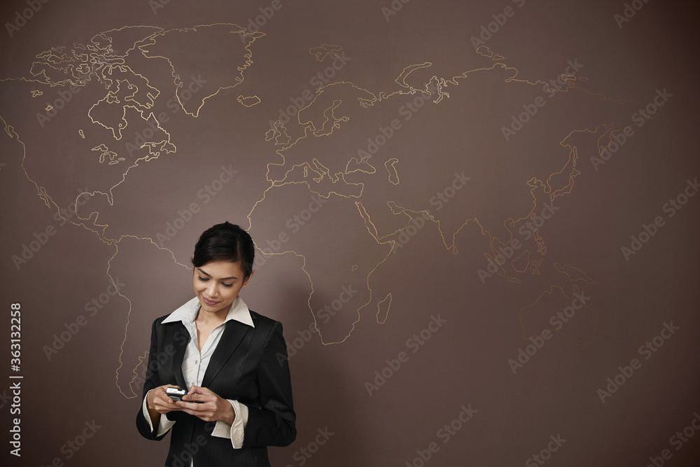 Businesswoman text messaging on the phone Businesswoman text messaging on the phone